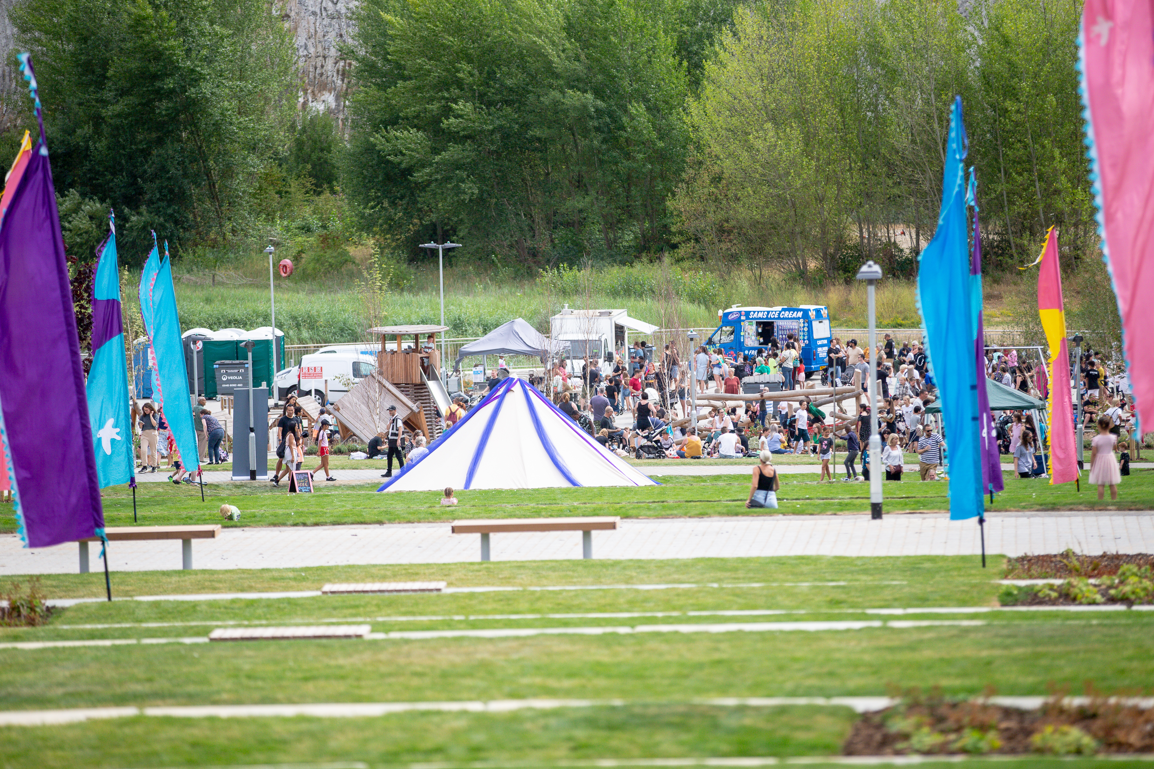 Image of tent and people enjoying outdoors festival