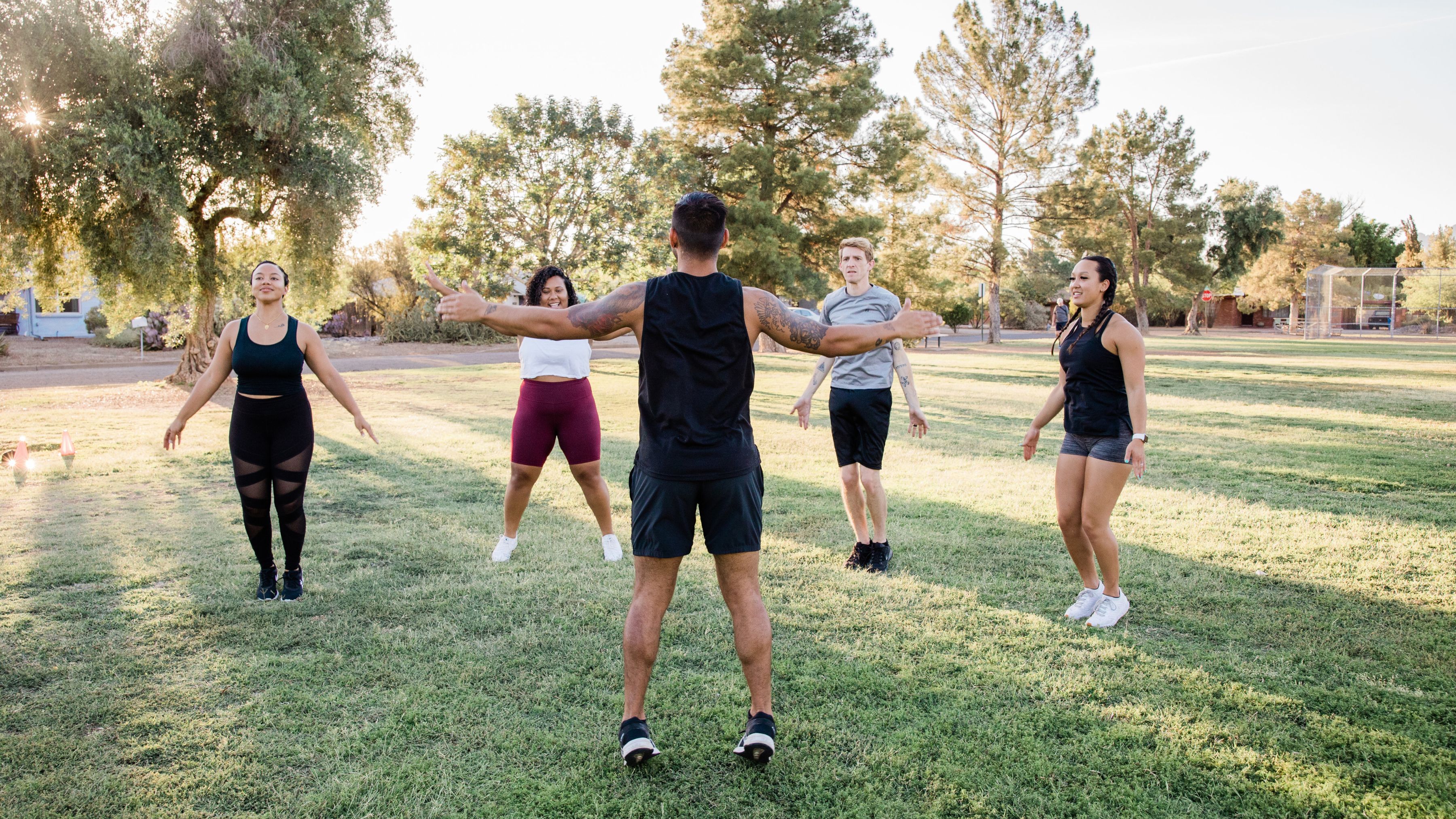 five people enjoying outdoor exercise