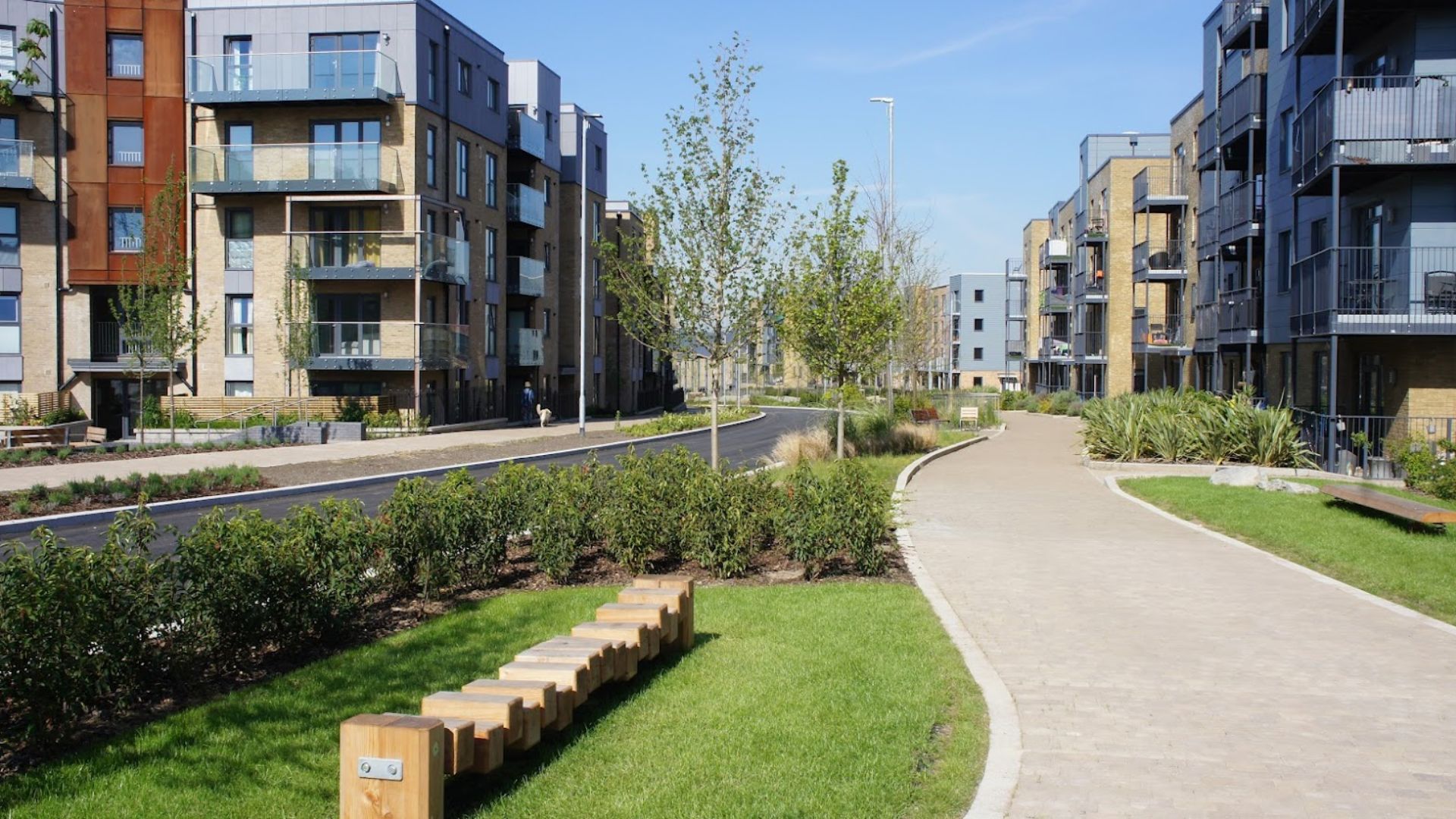 image of pedestrian route with road and apartments in background